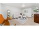 Bright living room with neutral tones, decorative rug, modern furniture, and a full length mirror at 1691 Roslyn St, Denver, CO 80220