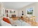 Bright living room with wood floors opens to kitchen and dining room at 1691 Roslyn St, Denver, CO 80220