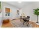 Well-lit office with a modern desk, hardwood floors, and ample natural light at 1691 Roslyn St, Denver, CO 80220