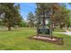 Sign for William H. McNichols Park with green grass and mature trees at 1691 Roslyn St, Denver, CO 80220