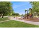 Neighborhood playground with slide, climbing area, and mature trees at 1691 Roslyn St, Denver, CO 80220