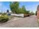 Neighborhood street with blue garage and white wooden fence at 1691 Roslyn St, Denver, CO 80220