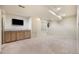 Finished basement with carpet, built-in cabinets and television at 13313 Elizabeth St, Thornton, CO 80241