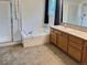 Well-lit bathroom featuring a bathtub, shower, and ample vanity space, perfect for relaxation at 13313 Elizabeth St, Thornton, CO 80241