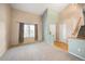 Bright living room with neutral walls, plush carpet, a large window, and staircase access to the second floor at 13313 Elizabeth St, Thornton, CO 80241