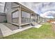 Backyard featuring a covered patio with screening, a landscaped lawn and exterior siding of home at 7167 Hyland Hills St, Castle Pines, CO 80108