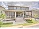 Spacious backyard showcasing a covered patio with outdoor furniture, a grill, and a landscaped lawn at 7167 Hyland Hills St, Castle Pines, CO 80108