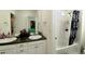 Bathroom featuring double vanity sinks, white cabinets, tile floors, and a bathtub-shower combo at 7167 Hyland Hills St, Castle Pines, CO 80108