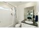 Clean bathroom featuring a shower-tub combo, white tile, and a large mirror with a vanity sink at 7167 Hyland Hills St, Castle Pines, CO 80108
