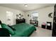 Cozy bedroom with a green bedspread, dark furniture, and a window with blinds for natural light at 7167 Hyland Hills St, Castle Pines, CO 80108