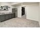 Bonus room featuring gray cabinets with granite countertops, stainless steel refrigerator, and walk-in closet at 7167 Hyland Hills St, Castle Pines, CO 80108