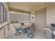 Covered patio featuring an outdoor table with chairs, grill, and decorative privacy screens for outdoor dining at 7167 Hyland Hills St, Castle Pines, CO 80108