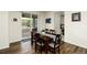 Cozy dining room with a wood table set for six, next to a sliding glass door to the porch at 7167 Hyland Hills St, Castle Pines, CO 80108