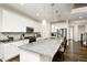 Modern kitchen with white cabinetry, stainless steel appliances, and a large center island at 7167 Hyland Hills St, Castle Pines, CO 80108