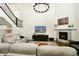 Spacious living room featuring a fireplace, television and comfortable seating at 7167 Hyland Hills St, Castle Pines, CO 80108