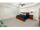 Spacious main bedroom with a tray ceiling, large bed, and ample natural light from multiple windows at 7167 Hyland Hills St, Castle Pines, CO 80108