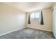 Cozy bedroom featuring soft carpet and a bright window, creating a relaxing atmosphere at 8770 Corona St # 102, Denver, CO 80229