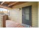 Inviting front porch with wood-beam ceiling and stylish welcome mat leading to the unit's front door at 8770 Corona St # 102, Denver, CO 80229