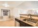 Well-lit kitchen area featuring a stainless steel sink and modern design elements at 8770 Corona St # 102, Denver, CO 80229