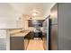 Stylish kitchen with modern stainless steel appliances and sleek countertops at 8770 Corona St # 102, Denver, CO 80229