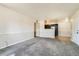Open-concept space with carpeted living room, seamlessly connected to the kitchen area at 8770 Corona St # 102, Denver, CO 80229