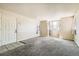 Bright living room with carpet floors and ample natural light streaming through large windows at 8770 Corona St # 102, Denver, CO 80229