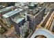 Aerial view of rooftop pool, lounge, and modern building in an urban location at 1750 Wewatta St # 1720, Denver, CO 80202