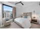 Bright bedroom featuring a large window with city views and a cozy armchair at 1750 Wewatta St # 1720, Denver, CO 80202