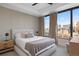 Inviting bedroom with a neutral color palette, city views, and a large window with modern window treatments at 1750 Wewatta St # 1720, Denver, CO 80202