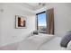Bright bedroom with a large window and a comfortable armchair at 1750 Wewatta St # 1720, Denver, CO 80202