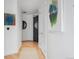 Hallway featuring light wood flooring, neutral walls, and modern art at 1750 Wewatta St # 1720, Denver, CO 80202