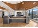 Modern kitchen featuring bar stool seating with city views and stainless steel appliances at 1750 Wewatta St # 1720, Denver, CO 80202