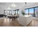 Bright open floor plan showcases a modern kitchen island, dining area, and inviting living space with floor to ceiling city views at 1750 Wewatta St # 1720, Denver, CO 80202