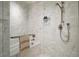 Beautiful marble tiled shower with a hand towel bar and high-end fixtures at 1750 Wewatta St # 1720, Denver, CO 80202