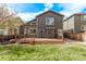 A well-maintained lawn and a wooden deck create a private outdoor oasis, ideal for relaxation and recreation at 5079 Morning Glory Pl, Highlands Ranch, CO 80130