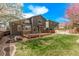 The backyard features a spacious lawn and a wooden deck, perfect for entertaining and outdoor relaxation at 5079 Morning Glory Pl, Highlands Ranch, CO 80130