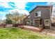 Enjoy the spacious backyard with its lush lawn, a wooden deck, and a charming fence for added privacy at 5079 Morning Glory Pl, Highlands Ranch, CO 80130