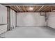 Unfinished basement with white insulation, grey floor, and utilities ready for customization at 5079 Morning Glory Pl, Highlands Ranch, CO 80130