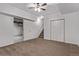 Finished basement with carpet, drop ceiling and door to laundry room at 5079 Morning Glory Pl, Highlands Ranch, CO 80130