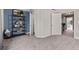 Bedroom with carpet, and an open closet, shelves and multiple doors at 5079 Morning Glory Pl, Highlands Ranch, CO 80130