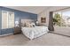 Cozy bedroom with a blue accent wall and natural light at 5079 Morning Glory Pl, Highlands Ranch, CO 80130