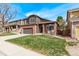 Inviting two-story home with a brick and siding exterior and a freshly mowed lawn at 5079 Morning Glory Pl, Highlands Ranch, CO 80130