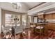 Open kitchen with hardwood floors, stainless steel appliances, and a breakfast bar at 5079 Morning Glory Pl, Highlands Ranch, CO 80130