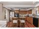 Well-appointed kitchen featuring stainless steel appliances and rich wood cabinetry at 5079 Morning Glory Pl, Highlands Ranch, CO 80130