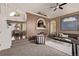 Cozy living room featuring carpeted floors, modern furniture, and bright, adjacent dining area at 5079 Morning Glory Pl, Highlands Ranch, CO 80130