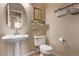 Stylish powder room with a pedestal sink, modern fixtures and decor at 5079 Morning Glory Pl, Highlands Ranch, CO 80130