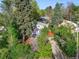 An aerial view of the home showing the red door, mature trees, and landscaping at 386 Colorado Blvd, Denver, CO 80206