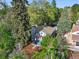 An aerial view of the home showing the red door, roof, mature trees, and landscaping at 386 Colorado Blvd, Denver, CO 80206