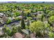 An aerial view of the home and neighborhood with mature trees and landscaping at 386 Colorado Blvd, Denver, CO 80206