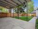 Backyard offers a stained fence, a detached garage, a covered patio, and a lush green lawn at 386 Colorado Blvd, Denver, CO 80206